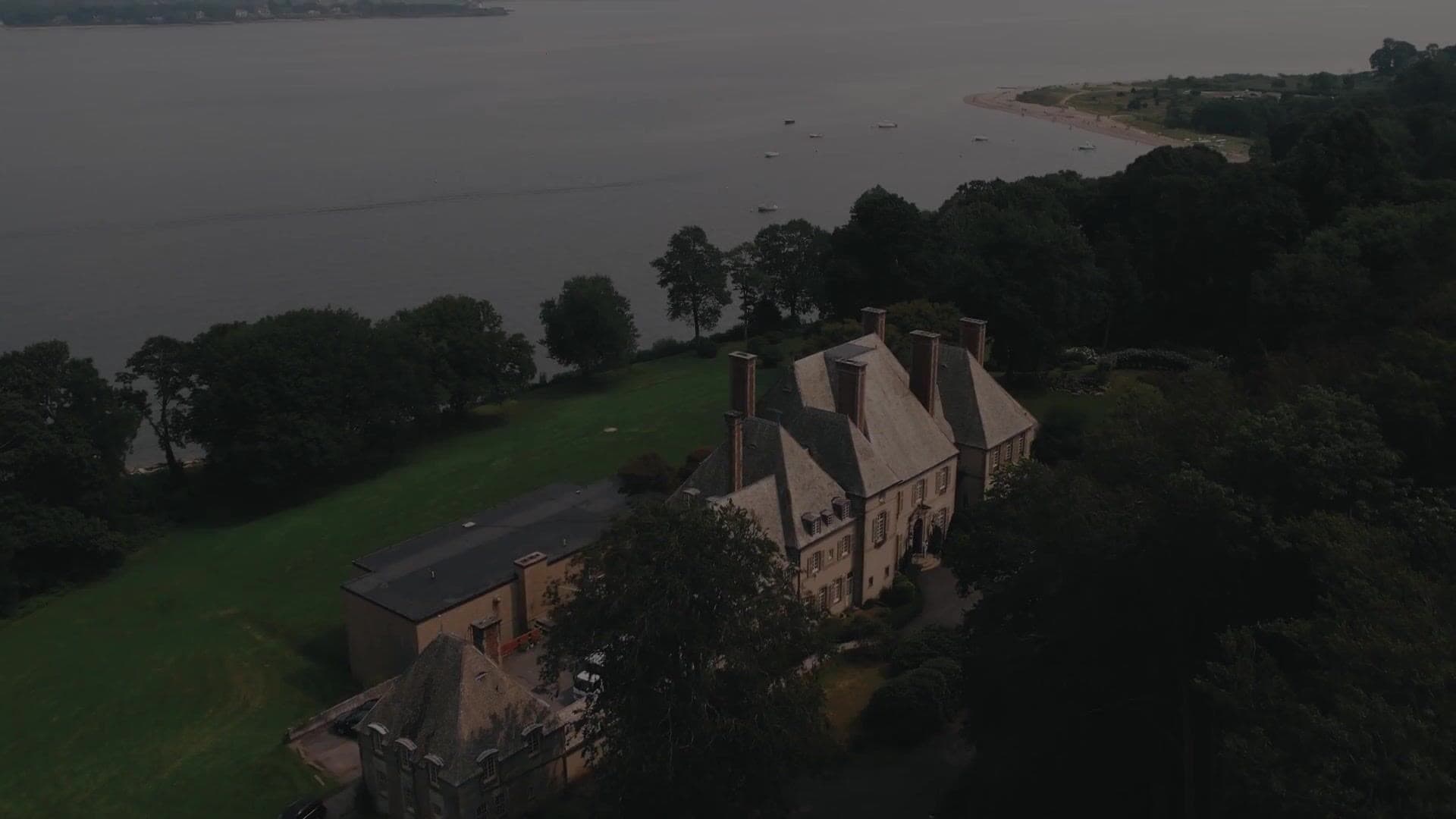 Glen Manor House in Portsmouth, Rhode Island, seen from the air at dusk with the Sakonnet River beyond