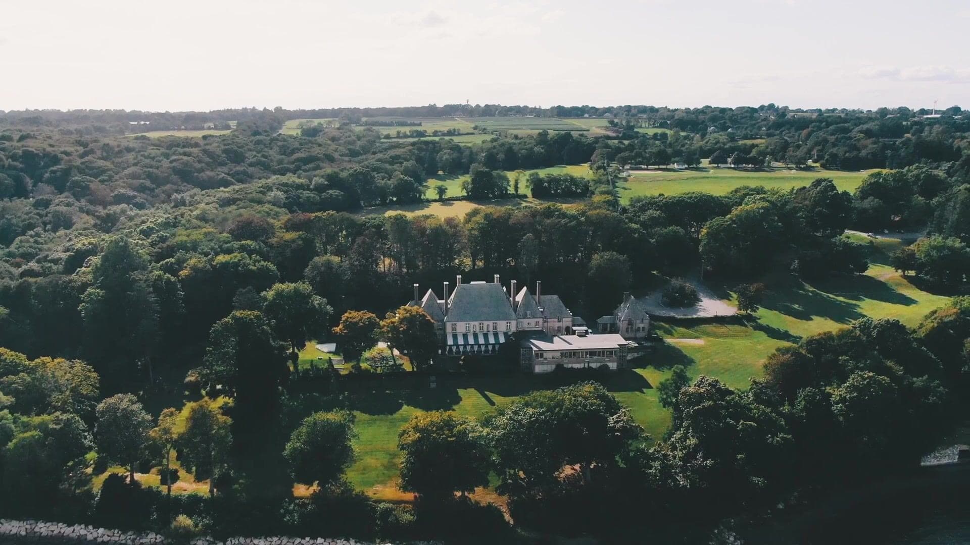 Glen Manor House seen from the air, surrounded by trees and open fields in Portsmouth, Rhode Island